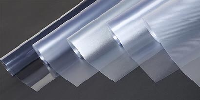 Five rolls of 3M overlaminates and protection films side-by-side showing different textures and opacity.
