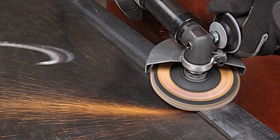 A close-up of a hand using grinder
