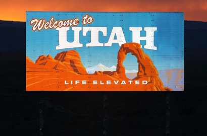 a 'welcome to utah' reflective sign glowing at dusk