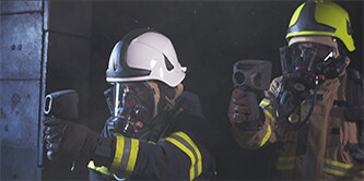 Firefighter wearing hands-free thermal imaging camera facepiece Scott Sight
