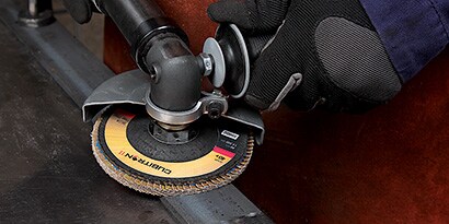 A close-up of a hand holding a circular disk
