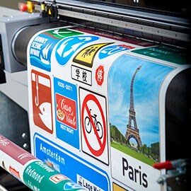Paris city icons being printed on to a sign sheet from a digital printer
