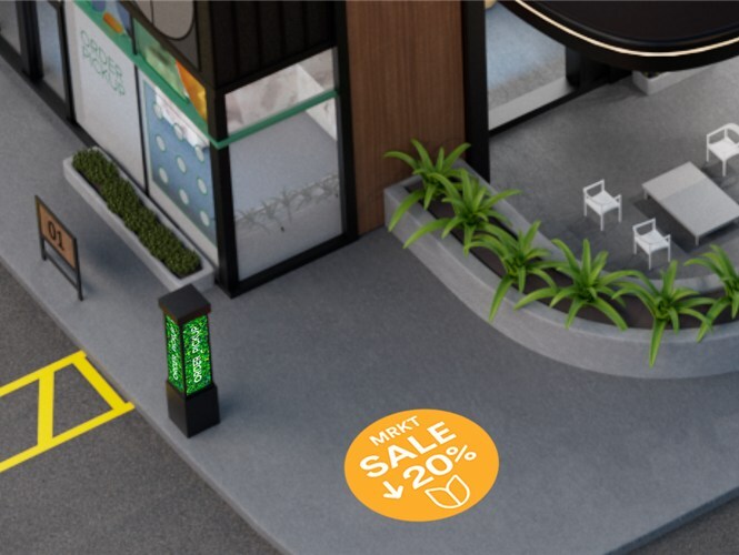 Storefront with illuminated signs and parking area, showcasing a green wall and delivery vans. 
