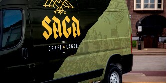 A hospital vehicle has a brightly colored graphic wrap that reflects light at nighttime.
