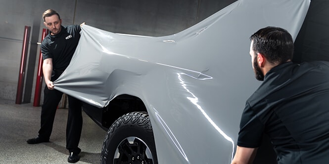 protective vinyl wrap for cars being installed