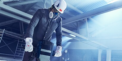 3M respirator worn by a man on a construction site
