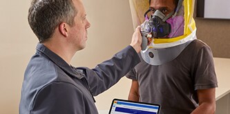worker participating in a respirator fit test with the wear it right app
