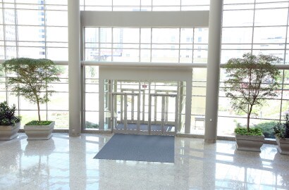 large glass entrance with plants in it