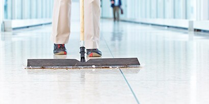 person sweeping the floor
