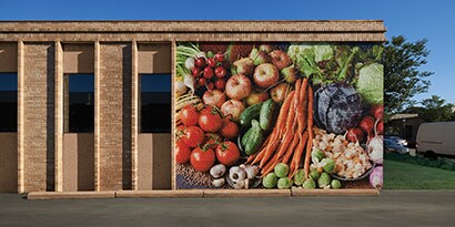 An exterior graphic wrap displays an image of colorful vegetables.
