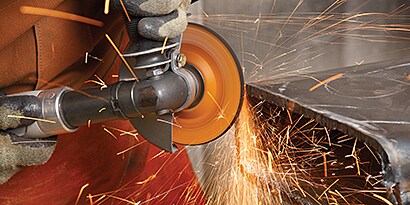 A person using a grinder
